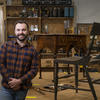 Daniel Clark poses with one of his restored chairs.