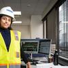 Ayesha Hassan poses for a photo in construction gear.