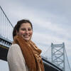 Maria Drawbaugh smiles in front of the Benjamin Franklin Bridge.
