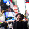 Jordan Dobson smiles for a photo in Times Square. 