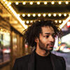 Jordan Dobson stands outside of a theater. 