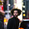 Jordan Dobson walks across busy NYC streets.