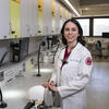 Honoree Haley Lockstein wearing a white labcoat and standing in a dental practice