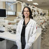Honoree Haley Lockstein wearing a white coat and standing in her lab