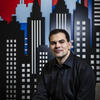 Zachary Gelb sitting in front of a mural of the Philadelphia skyline