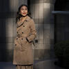 Honoree Binh Nguyen wearing a trench coat and standing outside the Visit Philadelphia building
