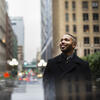 Honoree Xavier Conaway wearing a long coat and standing on Broad Street in downtown Philadelphia