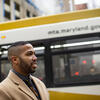 Xavier Conaway poses for a photo in front of Maryland public transit.