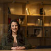 Honoree Rachel Greenberg sitting at a table and smiling at the camera