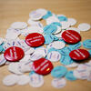 a pile of red, turquoise and white pins 
