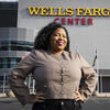 Honoree Lyric Hamilton standing in front of the Wells Fargo Center, where the Philadelphia Flyers hockey team plays
