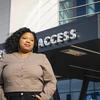 Lyric Hamilton standing outside the main entrance to the Wells Fargo Center