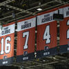 Orange flags hanging in the arena recognizing Flyers players and their jersey numbers