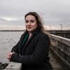 Honoree Brittney Martinez standing on a dock over the water and smiling