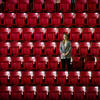 Marisa Brisbane stands amongst the stands at the basketball court.