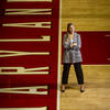 Marisa Brisbane poses for a photo on the University of Maryland basketball court. 