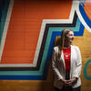 Honoree Marisa Bistbane standing in front of a mural wall in the University of Maryland area