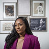 Charity Wells in front of a photo gallery.