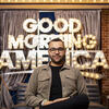 Niccolas Uff in front of Good Morning America signage. 