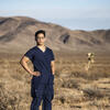 Honoree Binh Le wearing scrubs and standing in the Vegas desert
