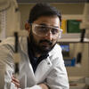 Honoree Devarshi Brahmbhatt wearing a white coat and safety goggles
