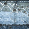 a collection of glass lab bottles on a shelf