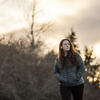 Rebecca Feldman walks along trees.
