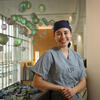 Hannah Calvelli smiles for a photo in scrubs.