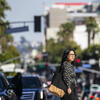 Samantha Tan walking across the street.