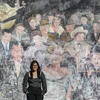 Samantha Tan posing in front of a mural.