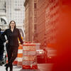 Abstract photo of Danielle Baer posing with construction cones.