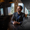 30 Under 30 honoree Victor Ficarra smiling and sitting at a table with his hands folded