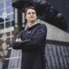 Joey Glennon Jr. standing in front of Carolina Panthers stadium.