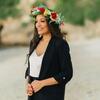 Honoree Jian Joyner wearing a flower crown and standing on a beach