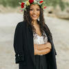 Honoree Jian Joyner standing on a beach and wearing a flower crown